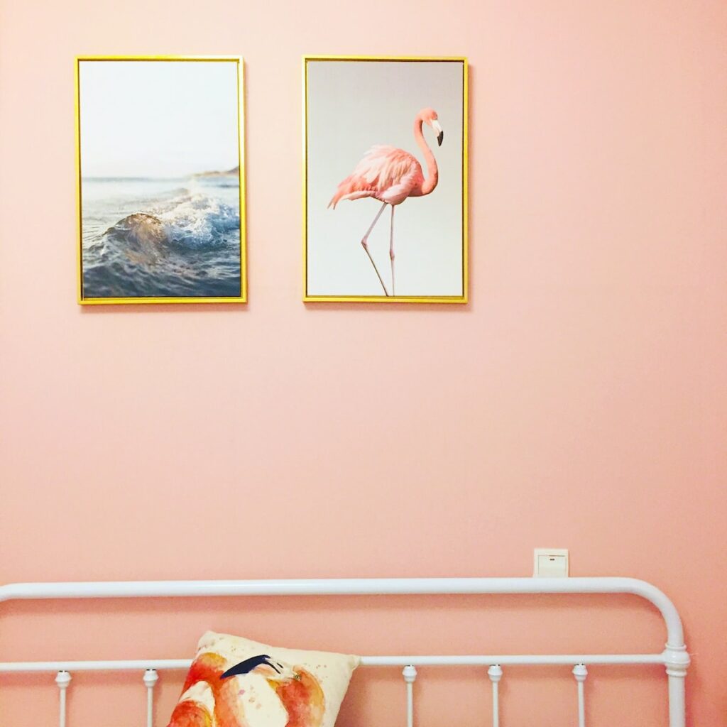 flamingo illustration with brown frame on wall